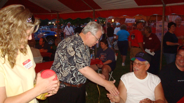 Pastor Mike congratulates the lucky 50/50 raffle winner.