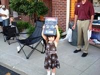 Little Miss Fox holds her daddy's sponsor plaque