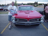 A happy Larry Kalka holds his SFI Outstanding Cruiser Award  for his hot 67 GTO
