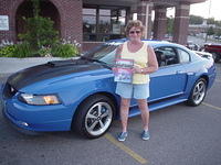 A very happy Judy Miller enjoys her 4 Seasons Best Late Model award for her 03 Stang.